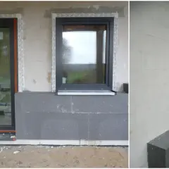 Budowa domu ze styropianu w toku. Widoczne okna, drzwi i szara izolacja termiczna.