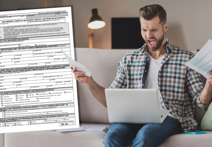 Frustracja przy wypełnianiu druku SD-Z2. Mężczyzna z laptopem i dokumentami wygląda na przytłoczonego.