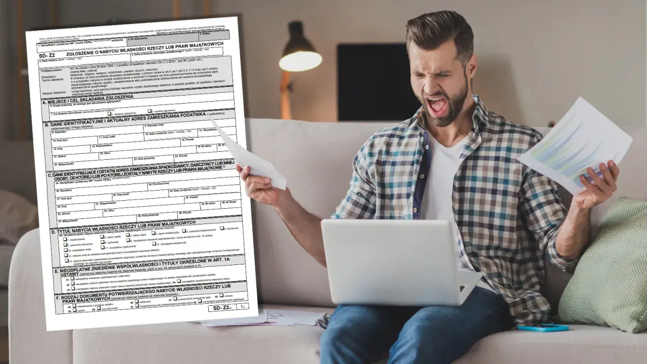 Frustracja przy wypełnianiu druku SD-Z2. Mężczyzna z laptopem i dokumentami wygląda na przytłoczonego.